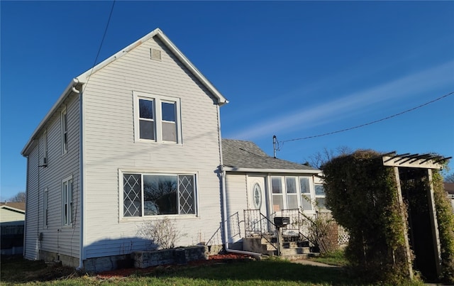 rear view of house with a lawn