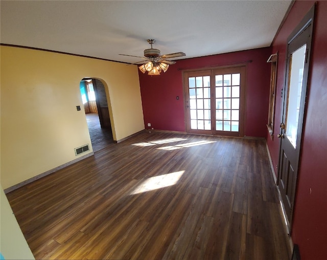 unfurnished room with ceiling fan and dark wood-type flooring