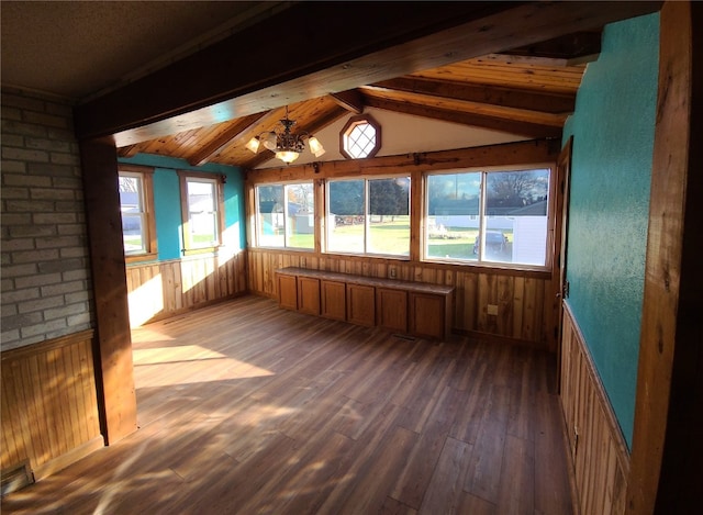 unfurnished sunroom with vaulted ceiling with beams and a notable chandelier