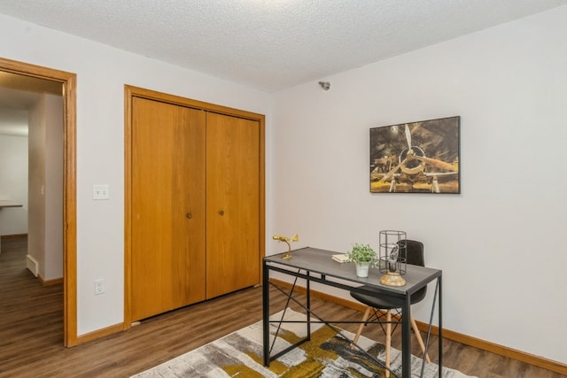 home office featuring hardwood / wood-style floors and a textured ceiling