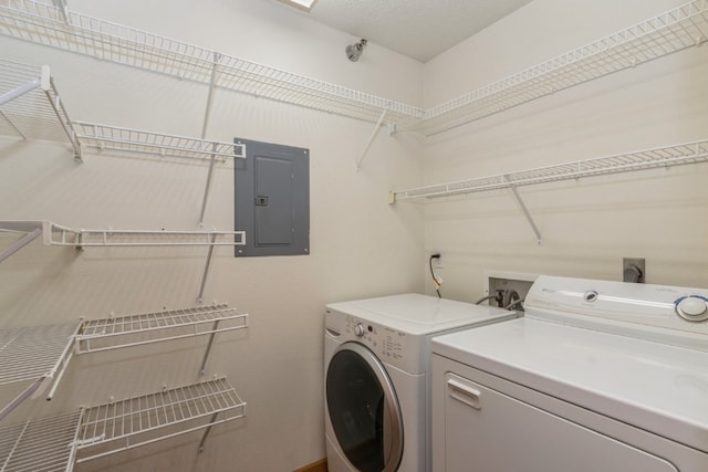 washroom with separate washer and dryer and electric panel