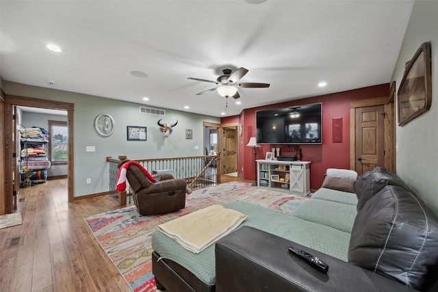 living room with ceiling fan and light hardwood / wood-style floors