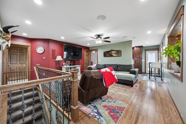 living room featuring hardwood / wood-style floors and ceiling fan