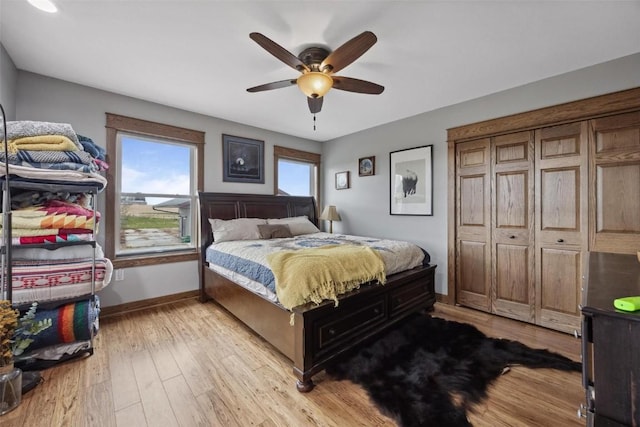 bedroom with ceiling fan and light hardwood / wood-style flooring