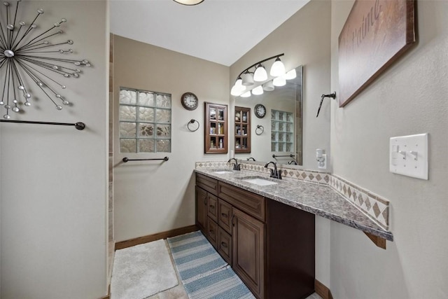 bathroom with lofted ceiling and vanity