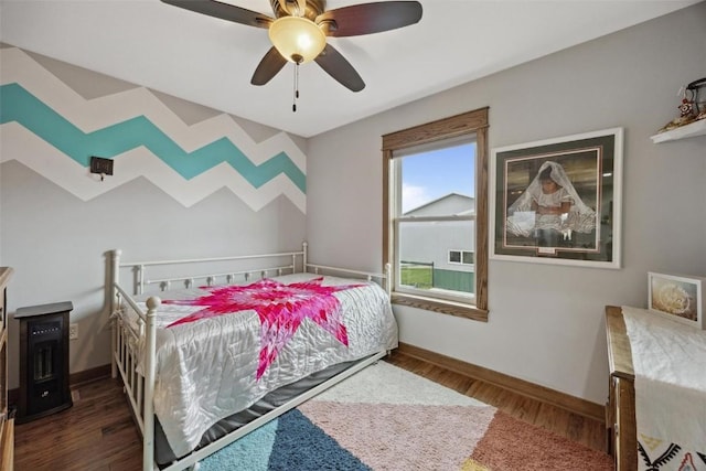 bedroom featuring dark hardwood / wood-style floors and ceiling fan