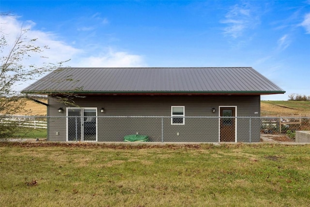 rear view of house with a yard