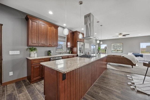 kitchen featuring stainless steel appliances, a kitchen island, island range hood, and decorative light fixtures