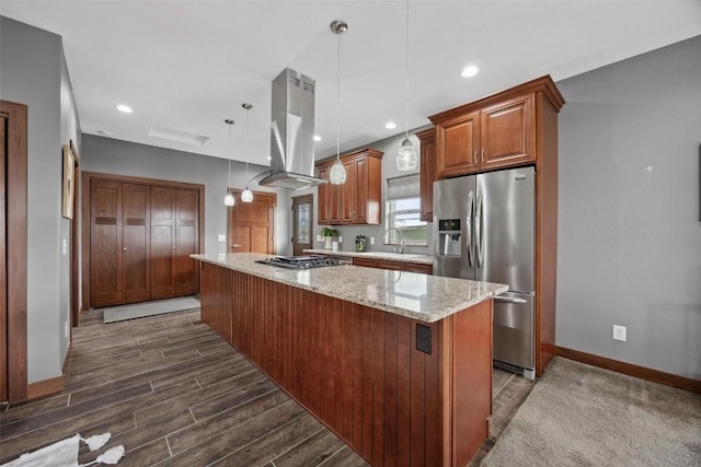 kitchen featuring sink, hanging light fixtures, a kitchen island, island exhaust hood, and stainless steel appliances