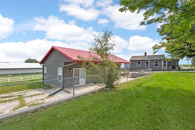 back of house with a lawn