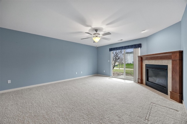 unfurnished living room with ceiling fan, light colored carpet, and a tiled fireplace