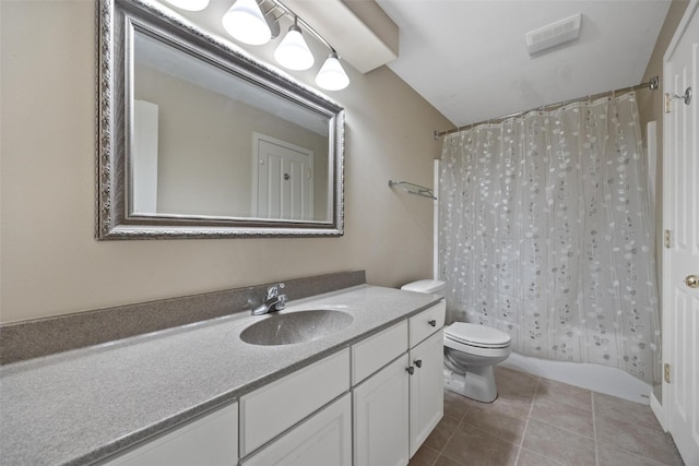 full bathroom with tile patterned floors, shower / bath combo with shower curtain, vanity, and toilet