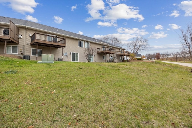 back of property featuring a yard and cooling unit