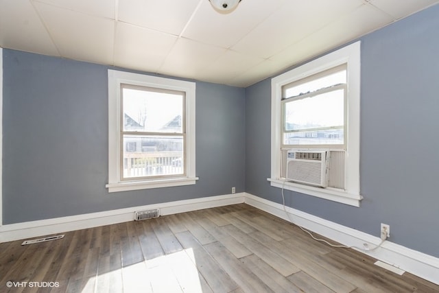 empty room with hardwood / wood-style flooring and cooling unit