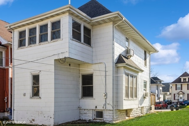 view of home's exterior with a lawn