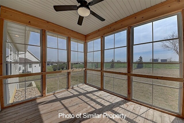 unfurnished sunroom with a wealth of natural light, ceiling fan, and wooden ceiling