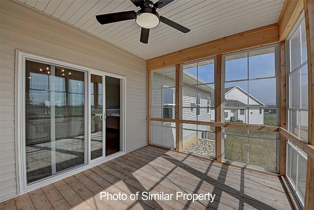 unfurnished sunroom with ceiling fan and wooden ceiling