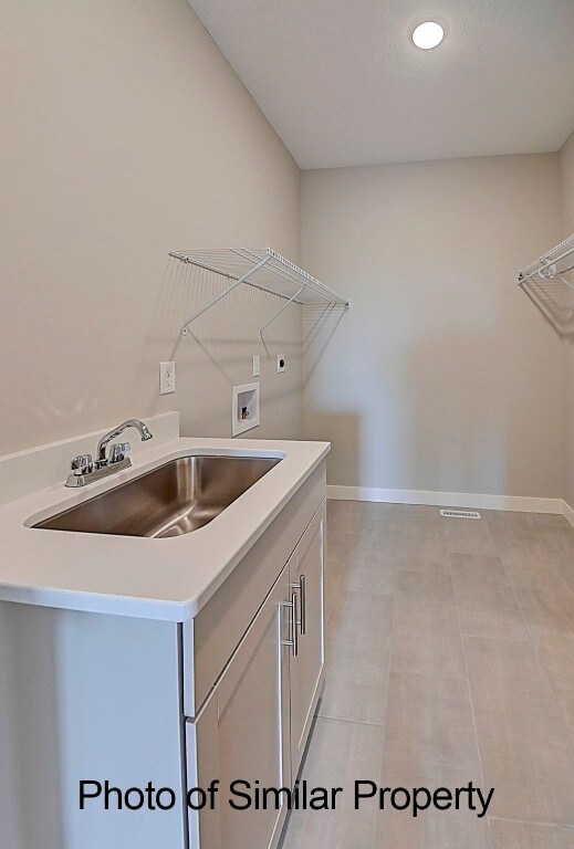 laundry room with washer hookup, electric dryer hookup, and sink