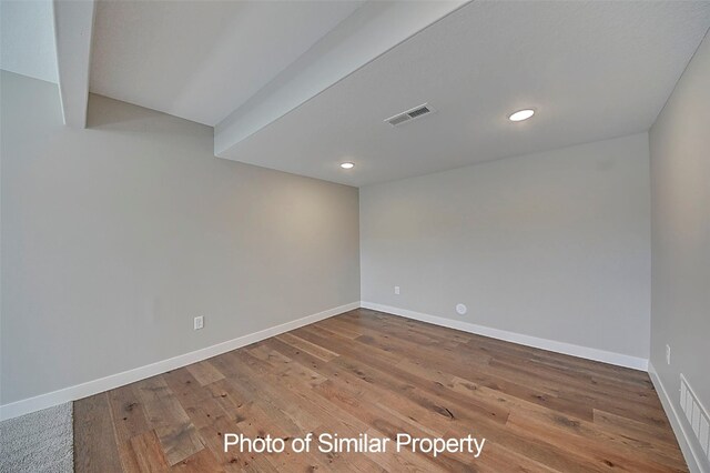 spare room with hardwood / wood-style flooring