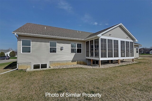 rear view of property with a lawn and a sunroom