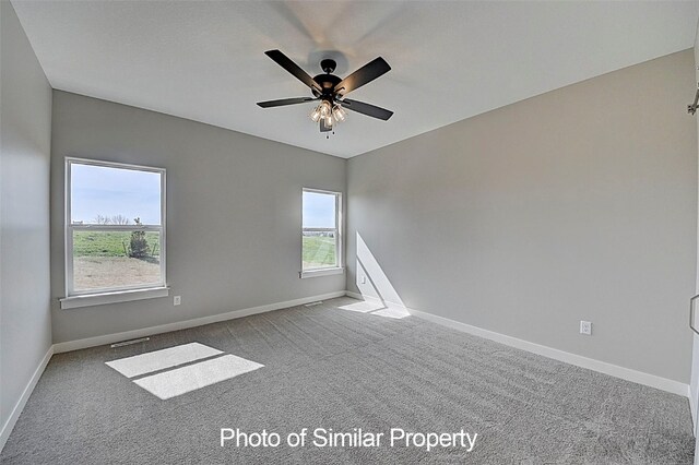 carpeted empty room with ceiling fan