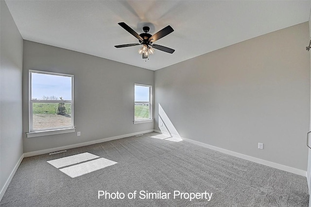 2933 Clubhouse Dr, Marion, IA 52302 - spare room featuring carpet flooring and ceiling fan