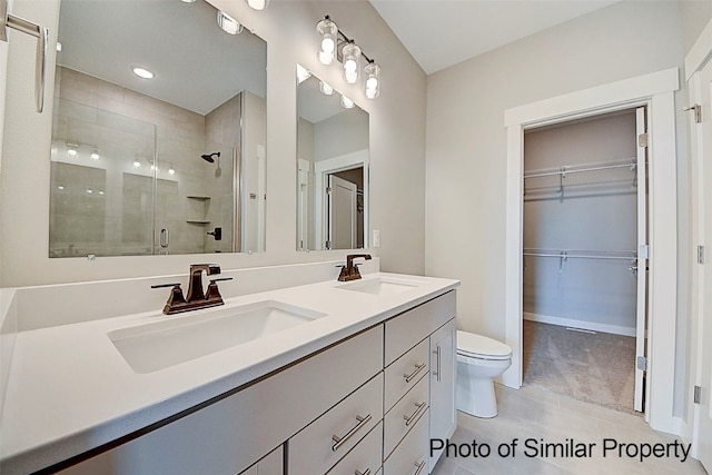 bathroom with tile patterned flooring, vanity, toilet, and a shower with door