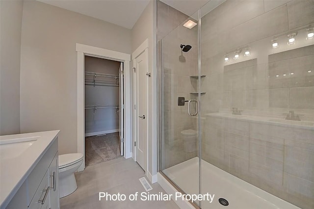 2933 Clubhouse Dr, Marion, IA 52302 - full bath with vanity, a shower stall, tile patterned flooring, and a spacious closet