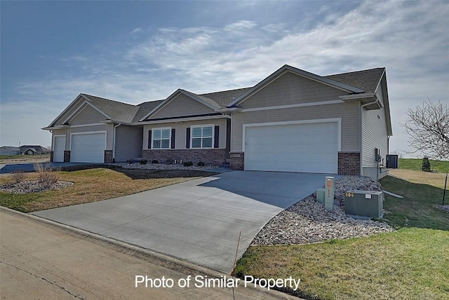 2933 Clubhouse Dr, Marion, IA 52302 - craftsman inspired home featuring an attached garage, driveway, a front yard, and brick siding