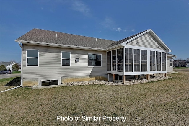 rear view of house with a lawn and a sunroom