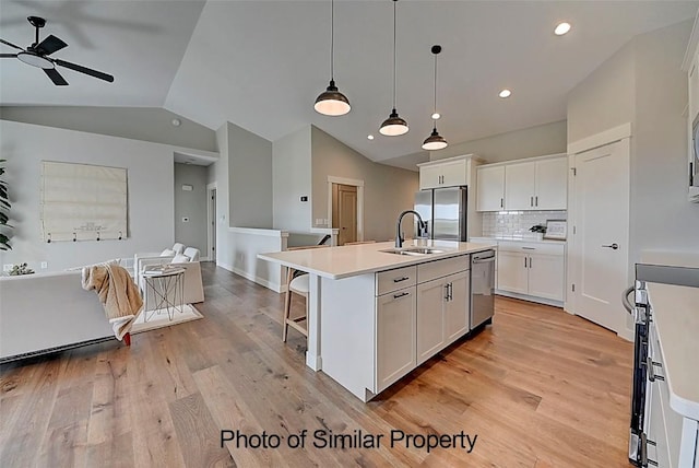 2933 Clubhouse Dr, Marion, IA 52302 - kitchen with appliances with stainless steel finishes, vaulted ceiling, a ceiling fan, light wood-type flooring, and white cabinets
