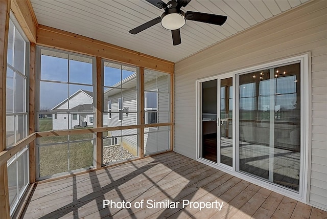 unfurnished sunroom featuring ceiling fan and wood ceiling