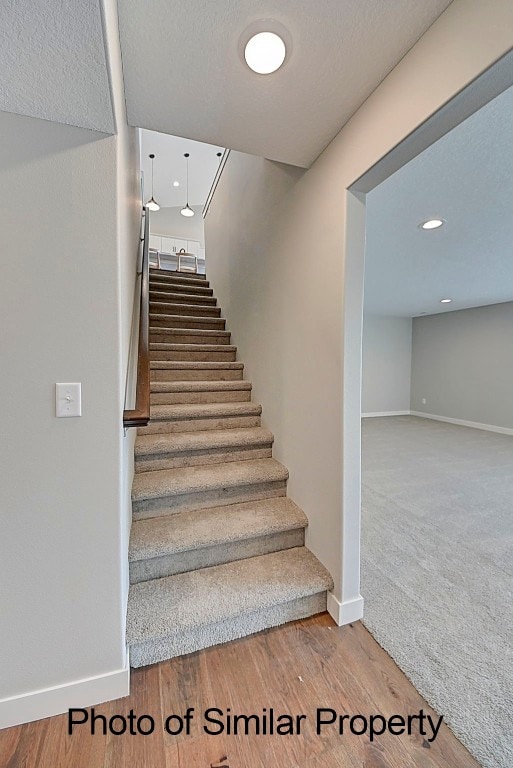 stairway with hardwood / wood-style floors