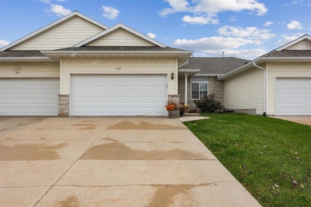 view of front of house with a front yard and a garage