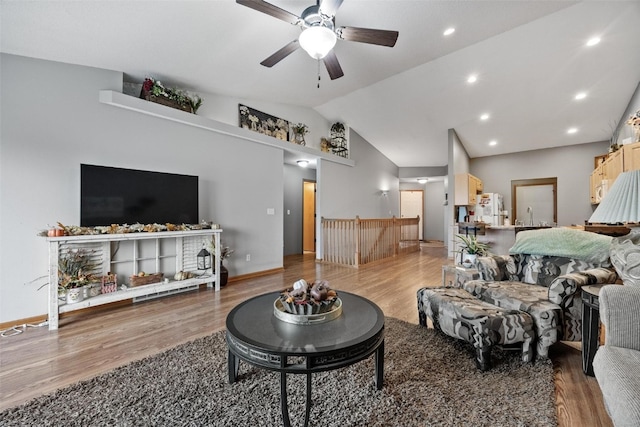 living room featuring wood-type flooring, high vaulted ceiling, ceiling fan, and sink