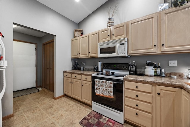 kitchen with lofted ceiling, light brown cabinets, light tile patterned flooring, and white appliances