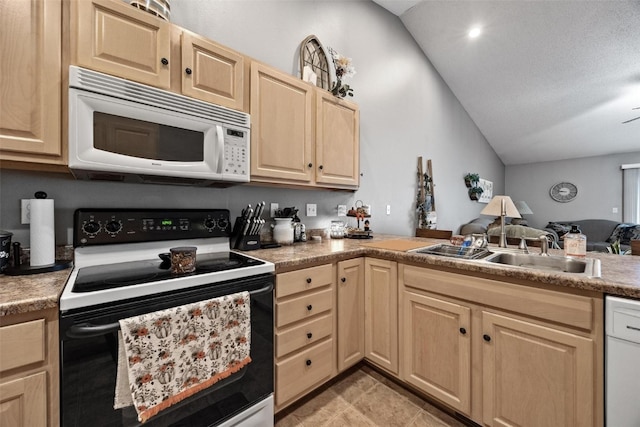 kitchen featuring light brown cabinets, white appliances, and vaulted ceiling