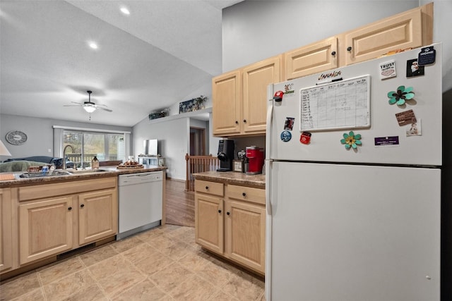 kitchen with sink, vaulted ceiling, a textured ceiling, white appliances, and light brown cabinetry