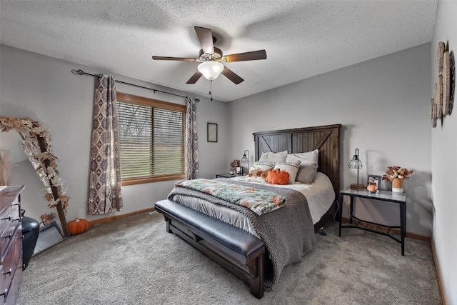 carpeted bedroom with a textured ceiling and ceiling fan