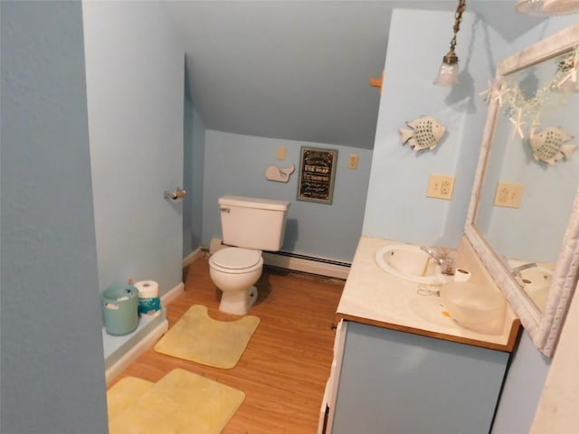 bathroom featuring vanity, vaulted ceiling, toilet, a baseboard radiator, and wood-type flooring