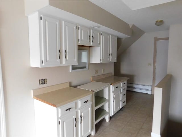 kitchen featuring white cabinetry and a baseboard radiator