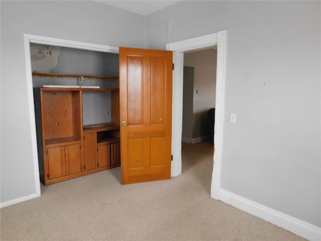 unfurnished bedroom featuring light carpet