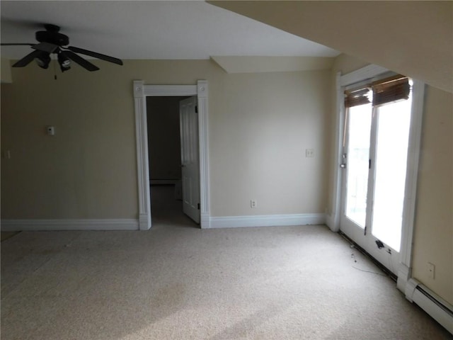 empty room with ceiling fan, a healthy amount of sunlight, light colored carpet, and a baseboard radiator