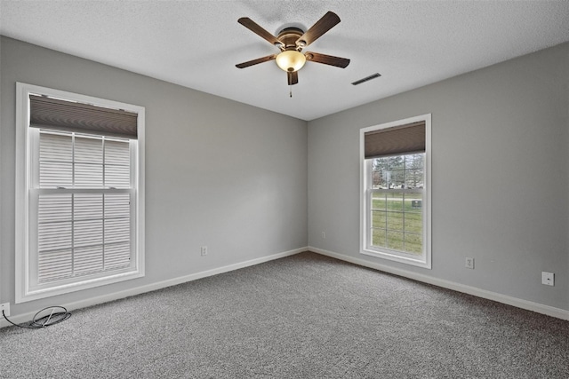 unfurnished room featuring a textured ceiling, carpet floors, and ceiling fan