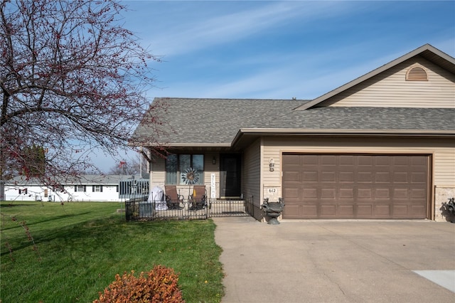 view of front of home featuring a garage and a front lawn