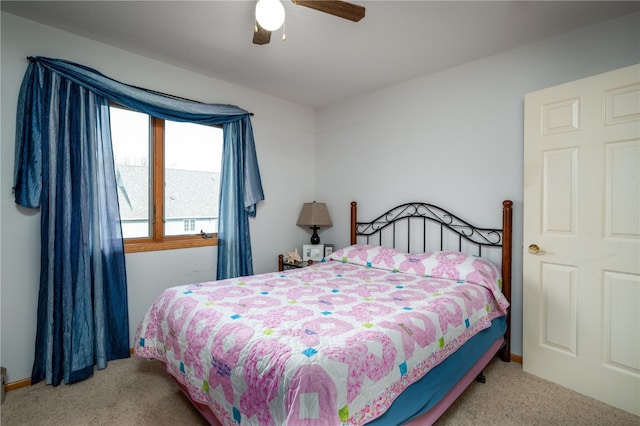 bedroom featuring ceiling fan and light carpet