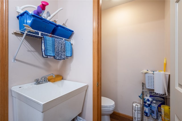 bathroom with sink, hardwood / wood-style floors, and toilet