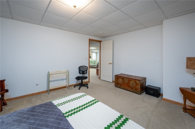 carpeted bedroom with a paneled ceiling