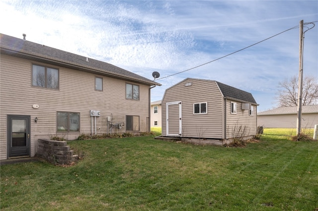 rear view of house featuring a lawn and a storage shed