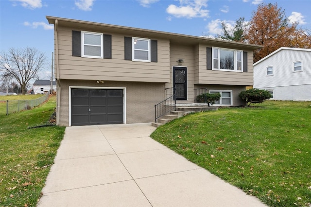 split foyer home with a front yard and a garage